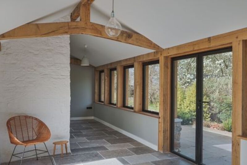 aluminium glazing with wooden beams in barn conversion